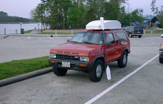 flats rat mouseboat kayak on top of car